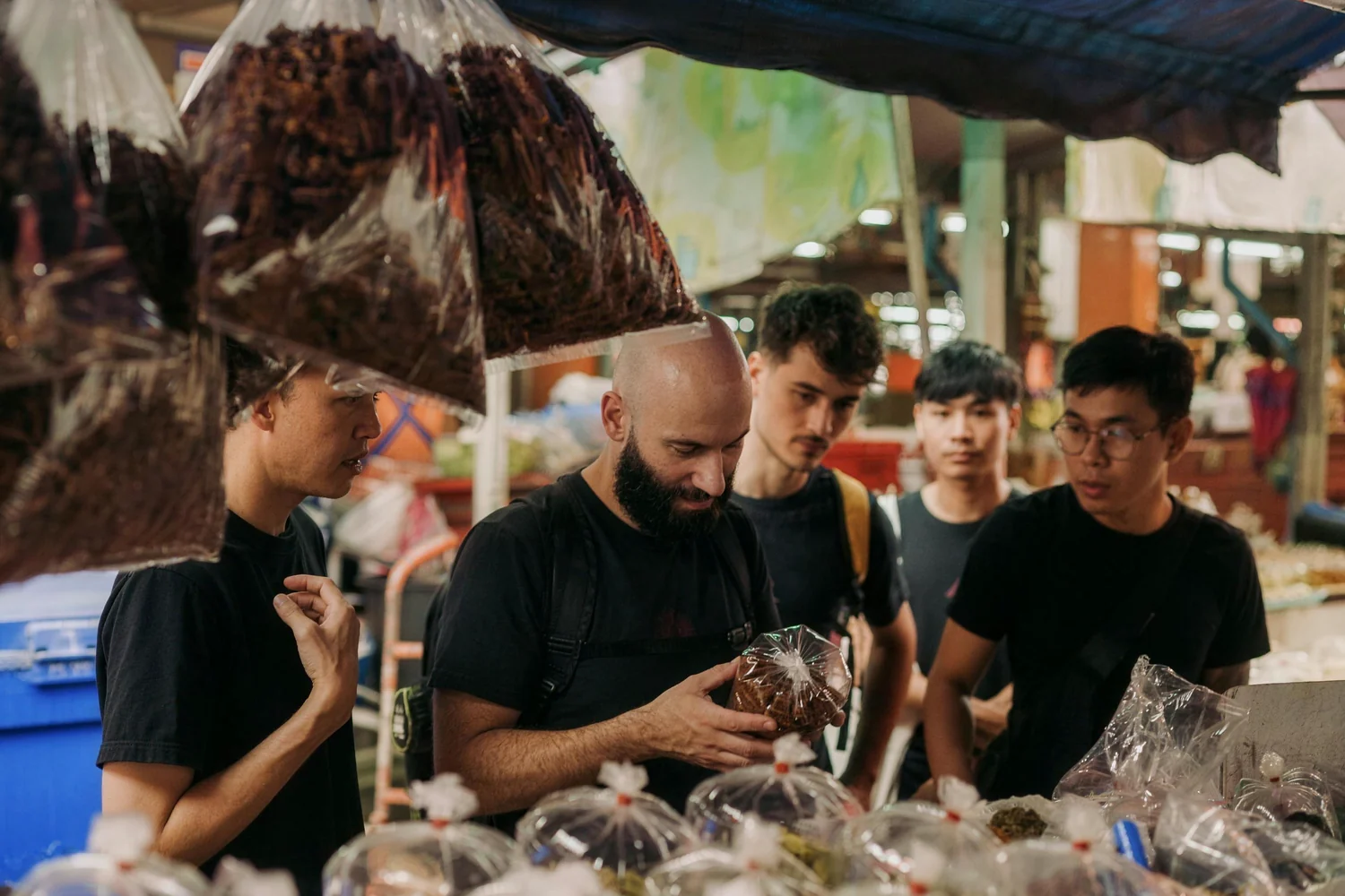 Head Chef Matteo and the Belén cooks choosing produce at a Chiang Mai market